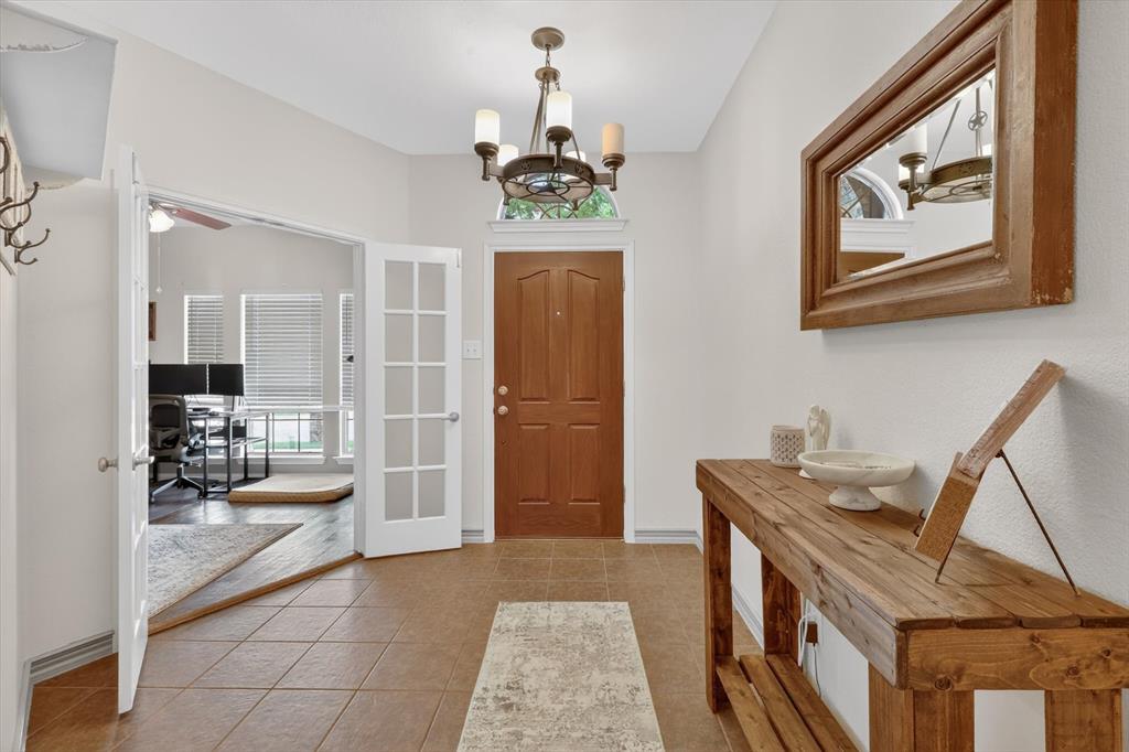 808 Mexicali Way Haslet, TX 76052 - Photo 2 of 25 Foyer entrance with a chandelier, a ceiling fan, light tile patterned flooring, and french doors