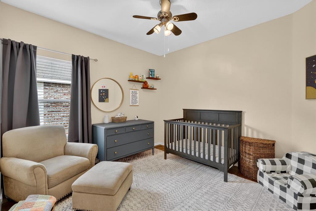 808 Mexicali Way Haslet, TX 76052 - Photo 5 of 25 Bedroom featuring a crib, ceiling fan, and wood finished floors