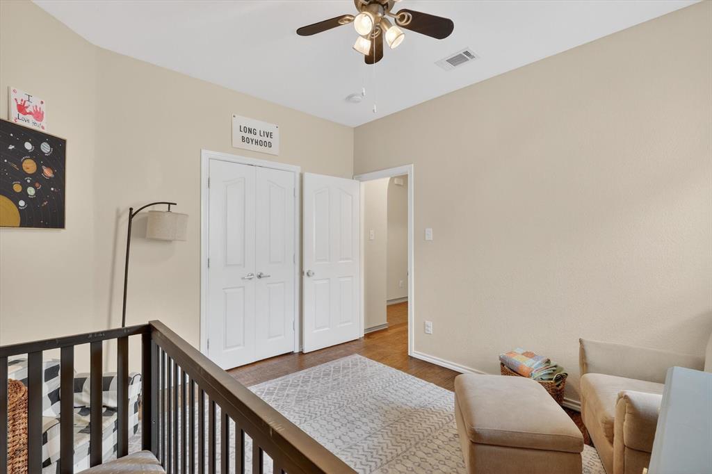 808 Mexicali Way Haslet, TX 76052 - Photo 6 of 25 Bedroom featuring a closet, wood finished floors, a ceiling fan, and a nursery area