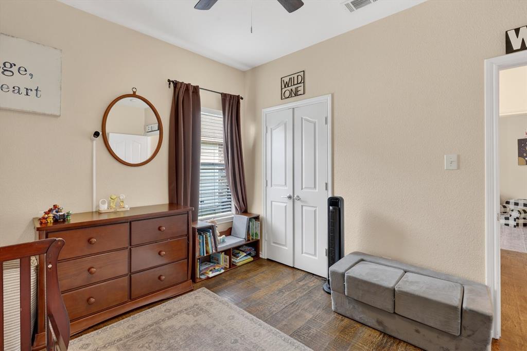 808 Mexicali Way Haslet, TX 76052 - Photo 7 of 25 Bedroom with dark wood-style floors, a closet, and a ceiling fan