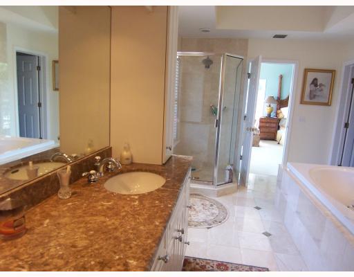 62 South River Road Stuart, FL 34996 - Photo 6 of 7 a bathroom with a granite countertop sink and a mirror