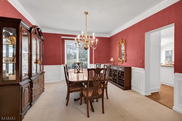 a kitchen with stainless steel appliances granite countertop a stove top oven a sink dishwasher a dining table and chairs with wooden floor