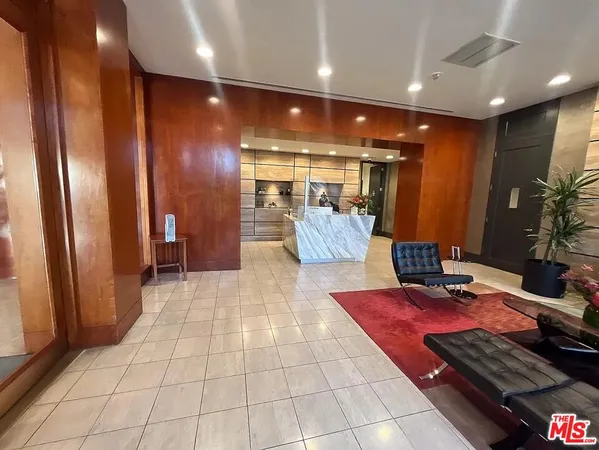 a lobby with furniture and a rug