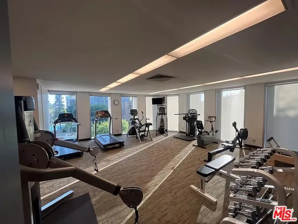 a living room with lots of furniture and gym equipment