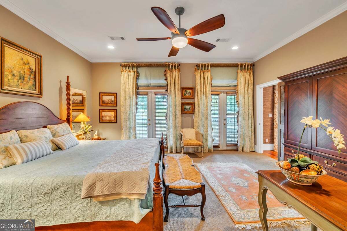 696 Cork Ferry Road Cordele, GA 31015 - Photo 23 of 79 a bedroom with a bed and large windows