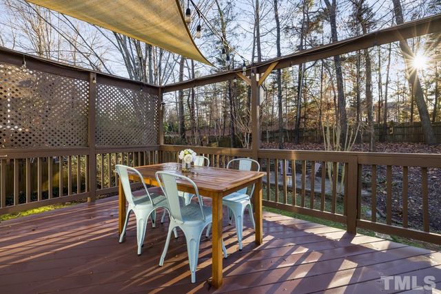 a view of a chairs and table in the balcony