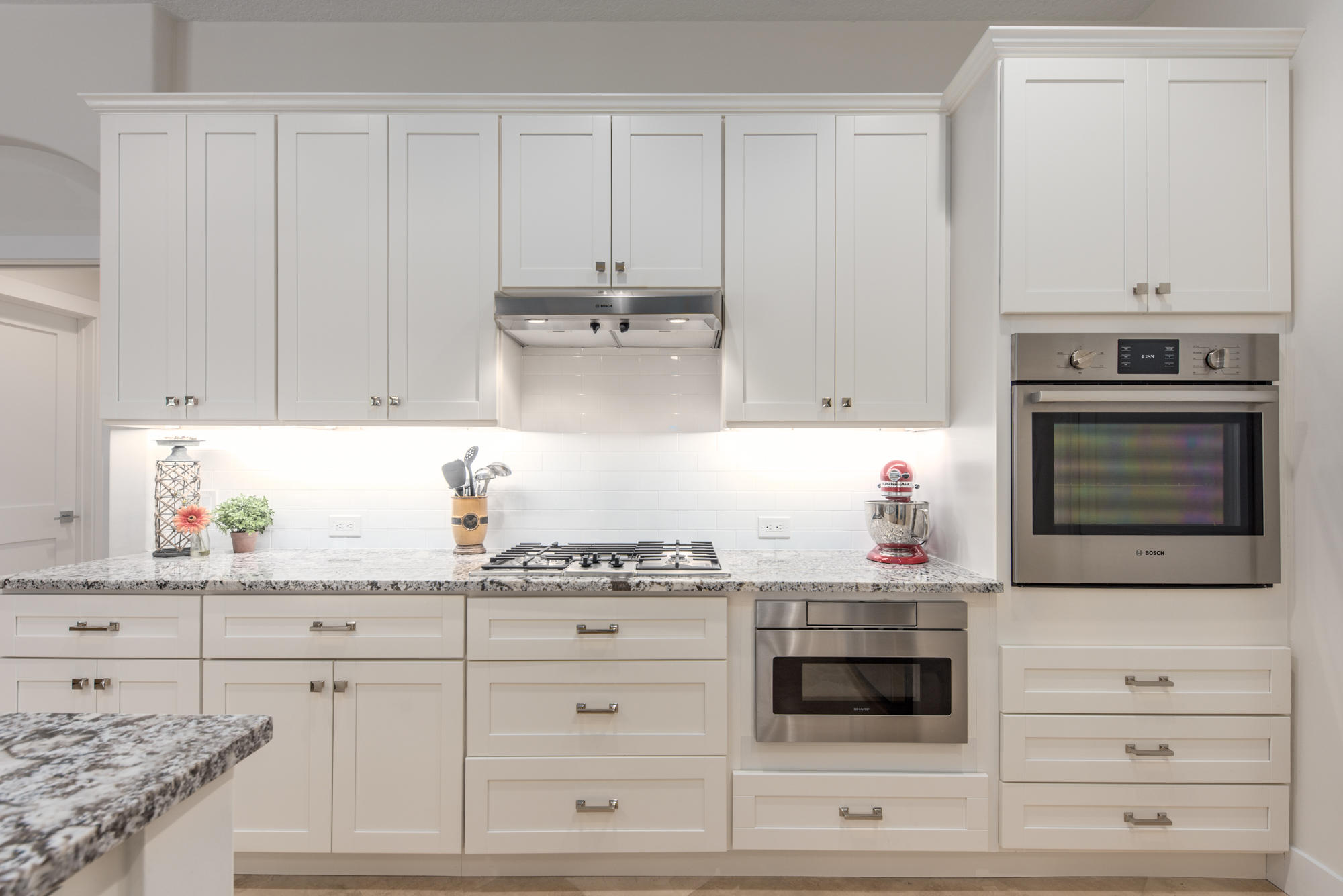 148 Beacon Lane Jupiter Inlet Colony, FL 33469 - Photo 20 of 30 a kitchen with granite countertop white cabinets and stainless steel appliances