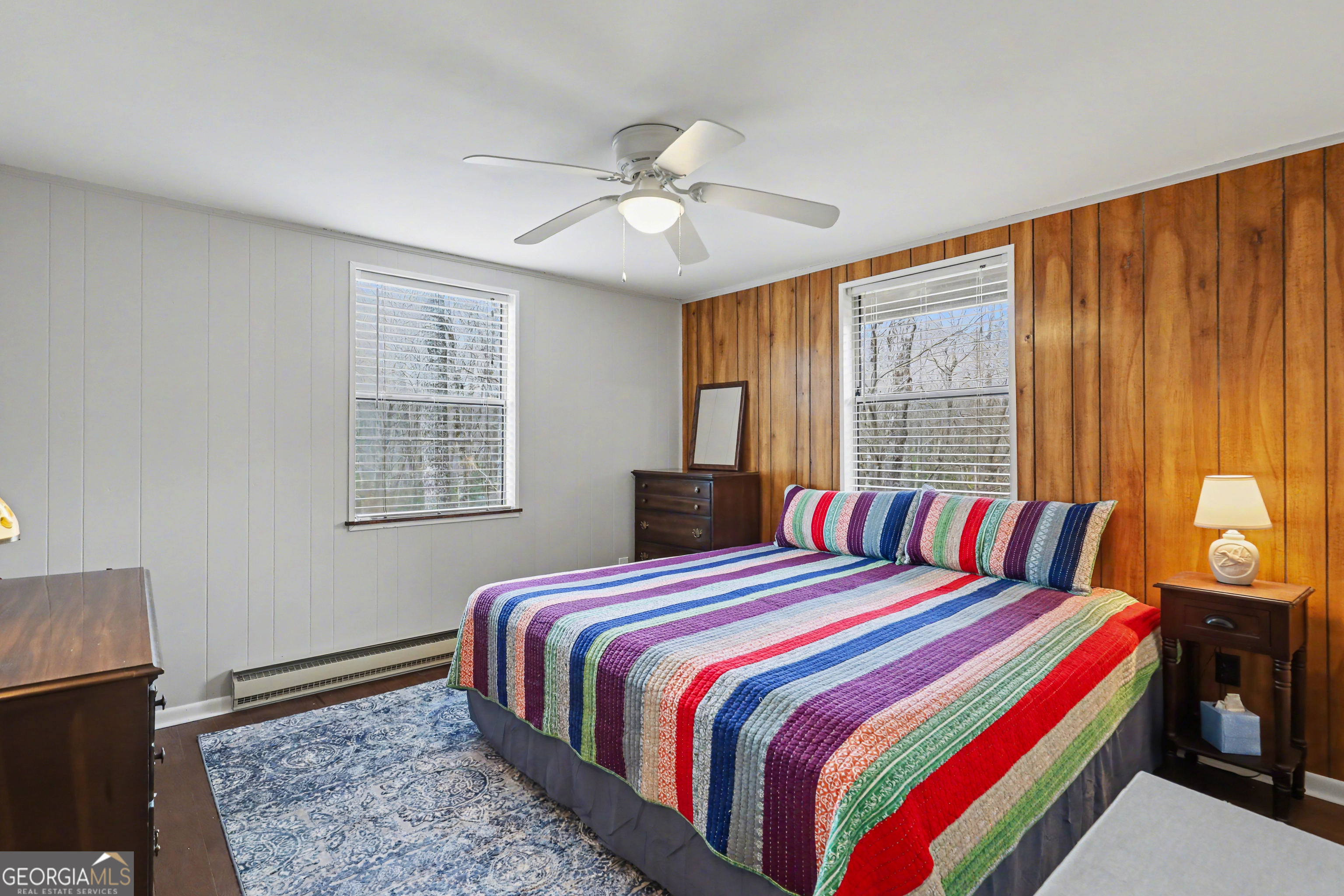 559 Maple Leaf Drive Dillard, GA 30537 - Photo 18 of 49 a bedroom with a bed and a chandelier