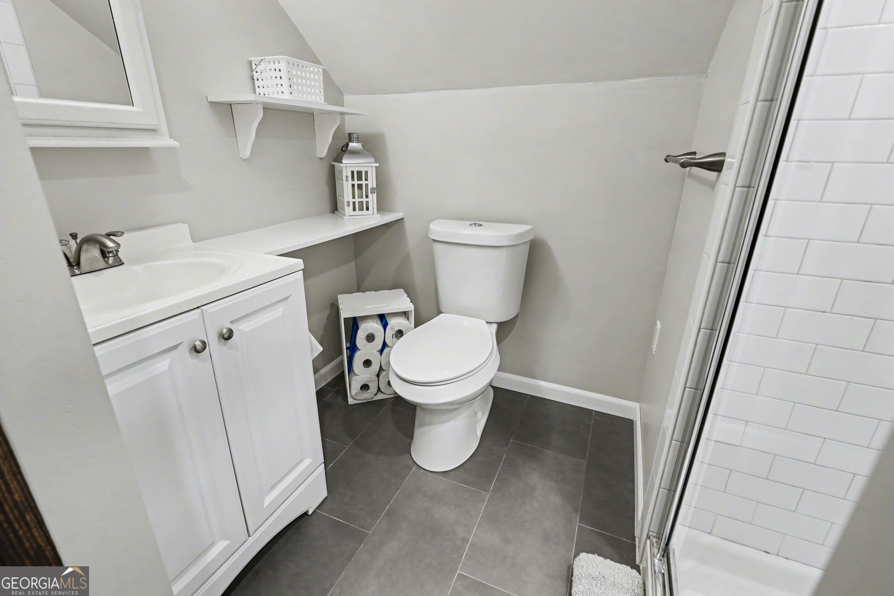 559 Maple Leaf Drive Dillard, GA 30537 - Photo 22 of 49 a white toilet sitting next to a white sink and vanity
