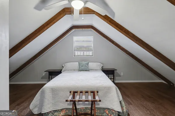 an aerial view of a house with swimming pool next to a yard