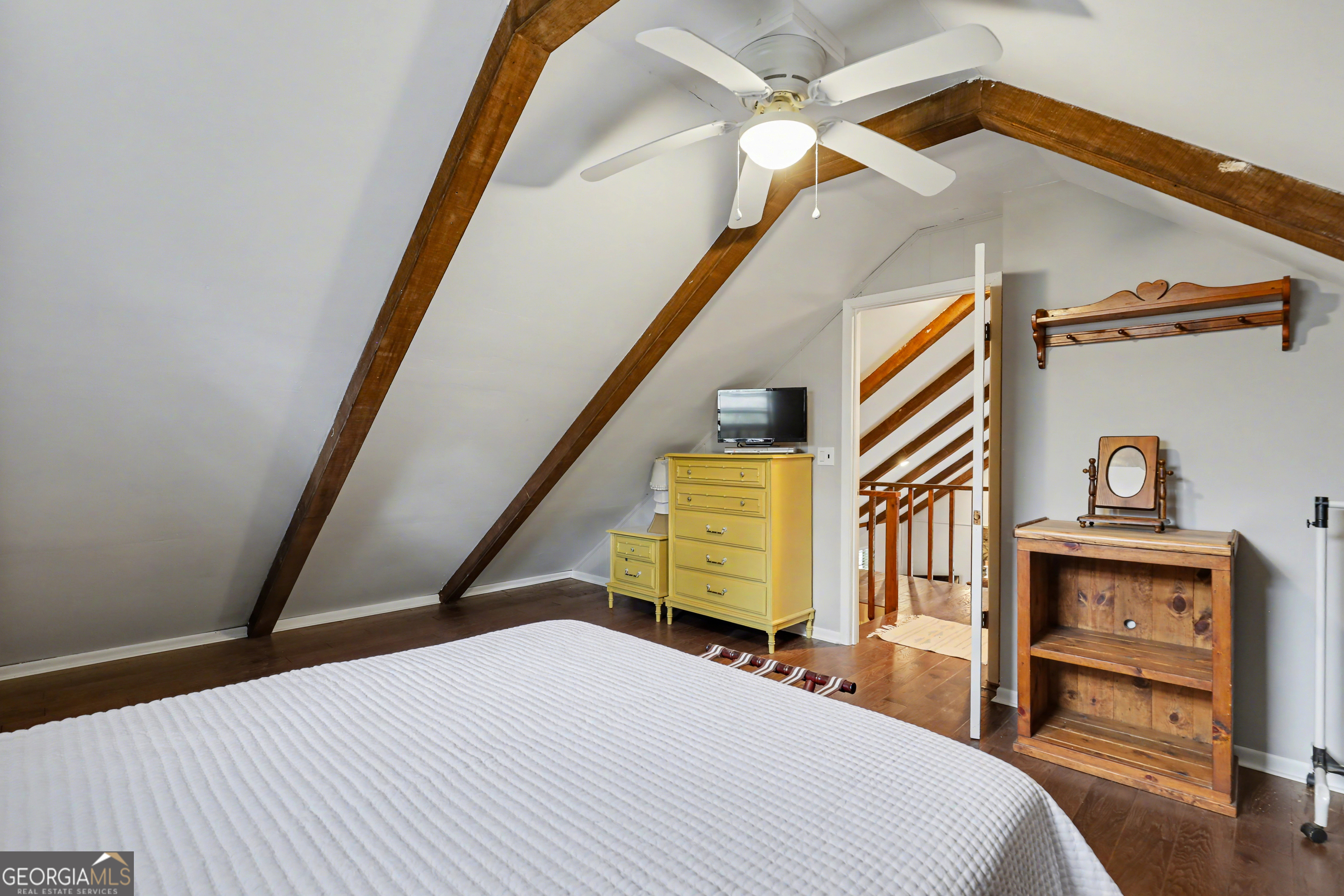 559 Maple Leaf Drive Dillard, GA 30537 - Photo 25 of 49 a bedroom with a bed and a chandelier