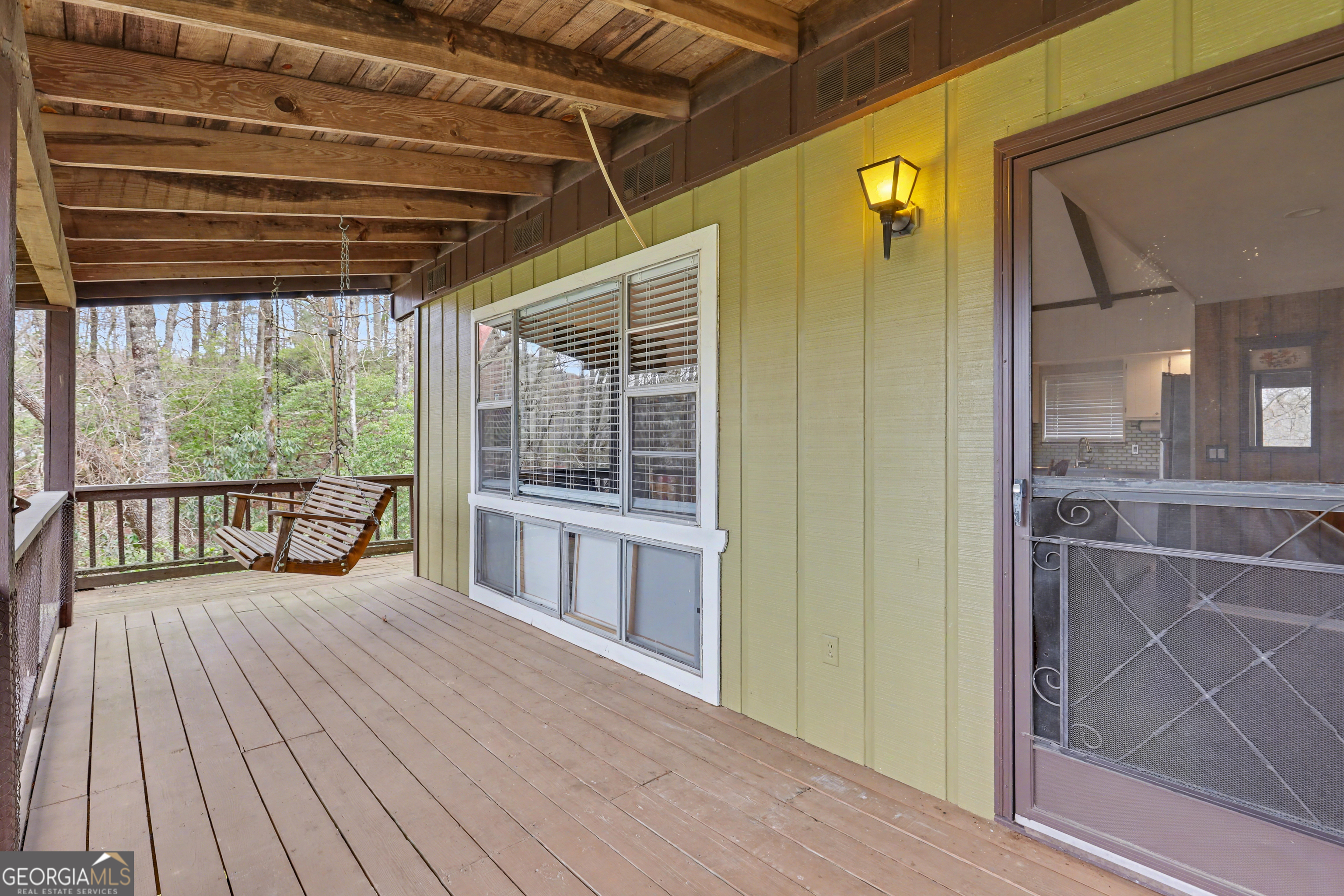 559 Maple Leaf Drive Dillard, GA 30537 - Photo 38 of 49 a view of a porch with wooden floor and windows