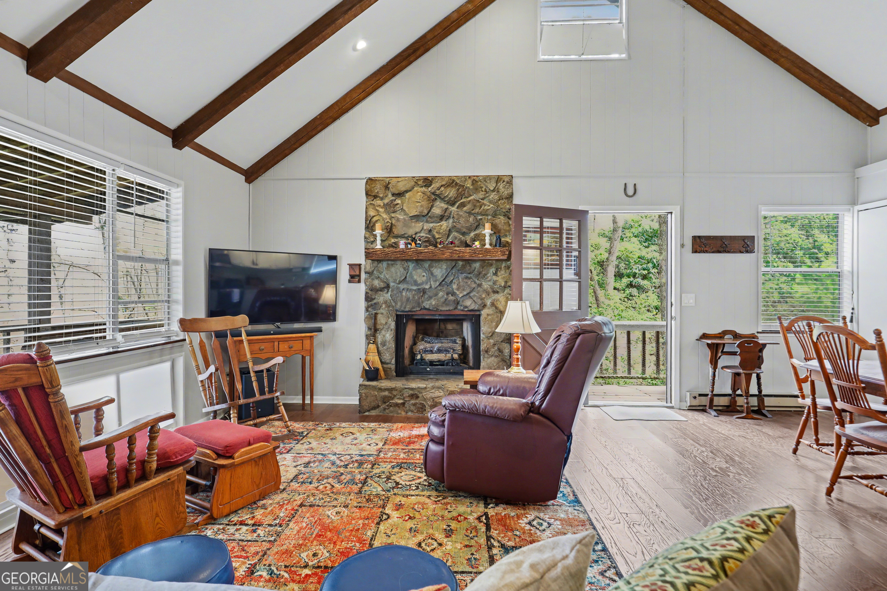 559 Maple Leaf Drive Dillard, GA 30537 - Photo 10 of 49 a living room with furniture a flat screen tv and a fireplace