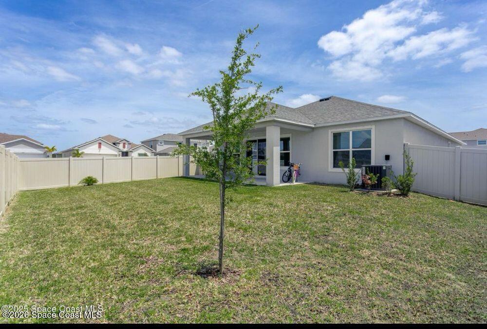 2792 Pinwherry Street Palm Bay, FL 32907 - Photo 15 of 19 a view of a house with backyard and a tree