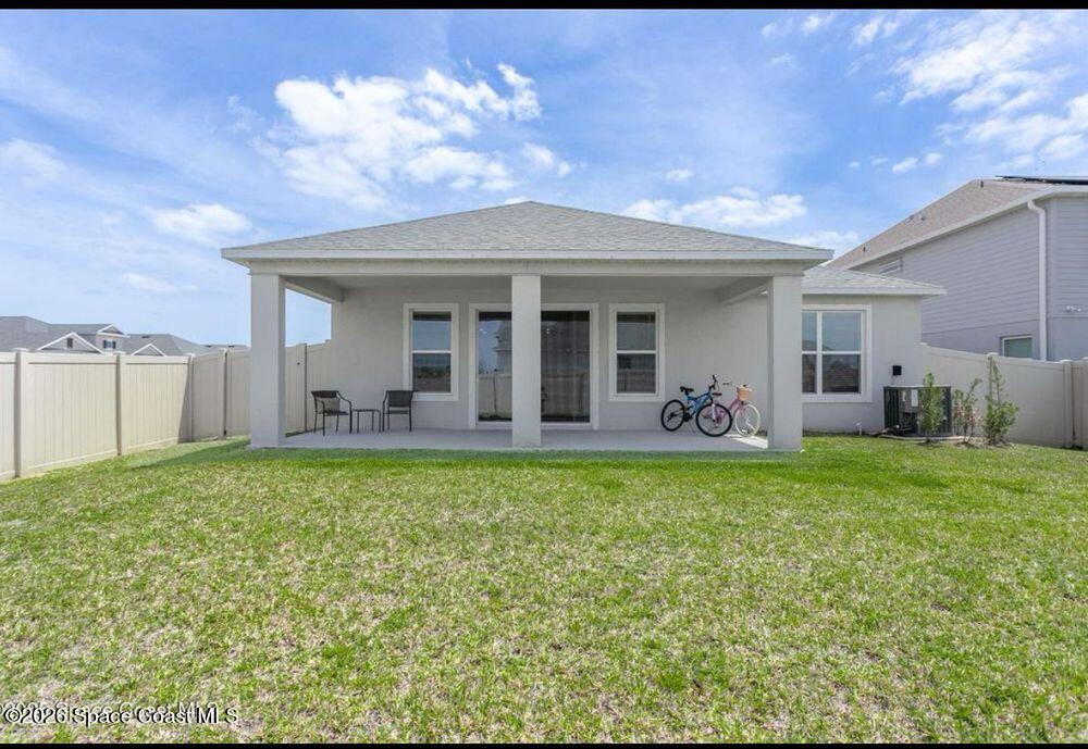 2792 Pinwherry Street Palm Bay, FL 32907 - Photo 16 of 19 a view of a house with backyard porch and outdoor seating