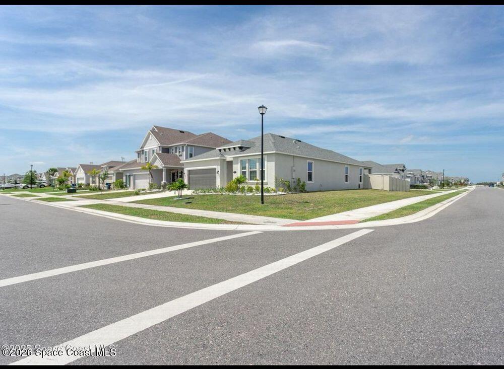 2792 Pinwherry Street Palm Bay, FL 32907 - Photo 3 of 19 a view of a big room with a big yard and large trees