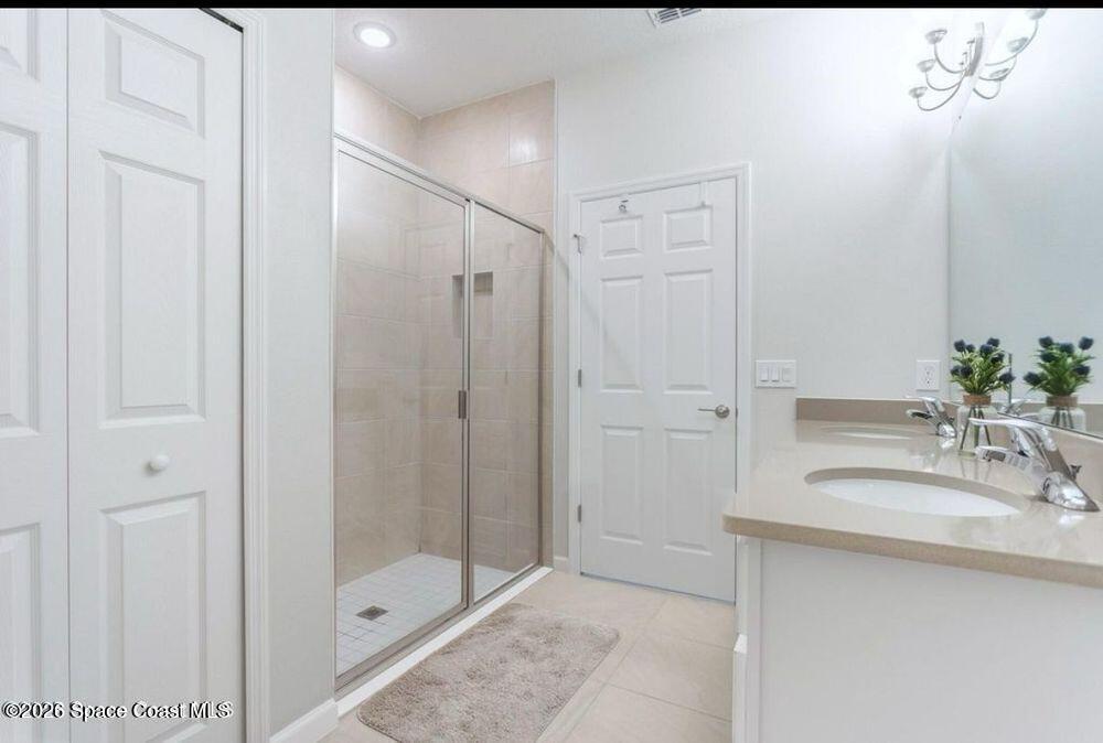 2792 Pinwherry Street Palm Bay, FL 32907 - Photo 6 of 19 a bathroom with a shower sink and mirror