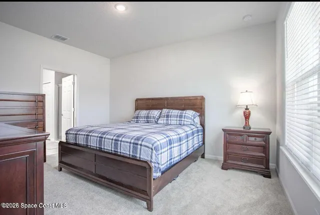 a bedroom with a bed and a cabinets