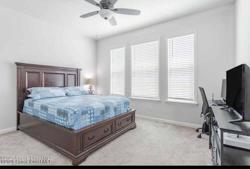 2792 Pinwherry Street Palm Bay, FL 32907 - Photo 8 of 19 a bedroom with a bed and a window