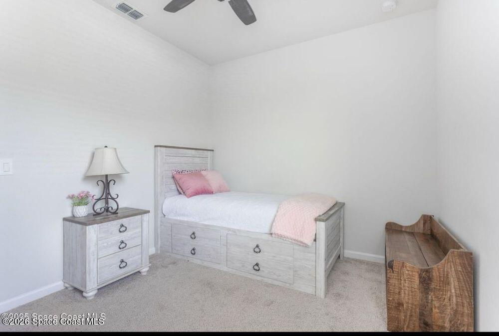 2792 Pinwherry Street Palm Bay, FL 32907 - Photo 9 of 19 a bedroom with a bed and a night stand