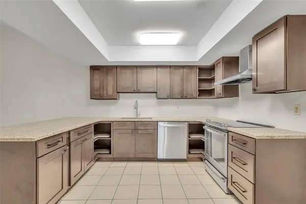 a kitchen with stainless steel appliances granite countertop a sink and cabinets