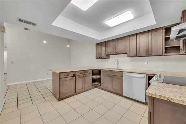 a kitchen with stainless steel appliances granite countertop a sink and cabinets