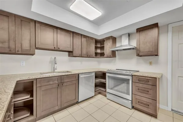 a kitchen with stainless steel appliances granite countertop a sink and cabinets