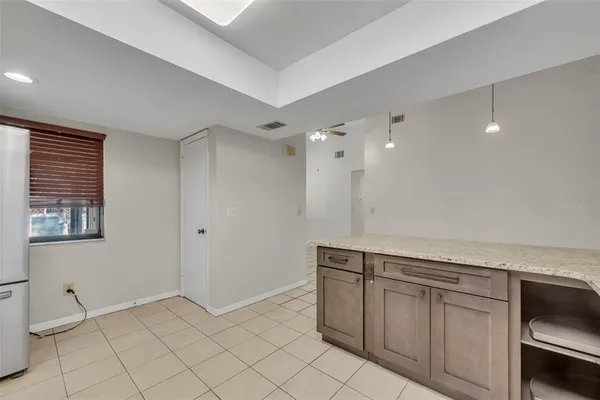 a view of a kitchen with white cabinets