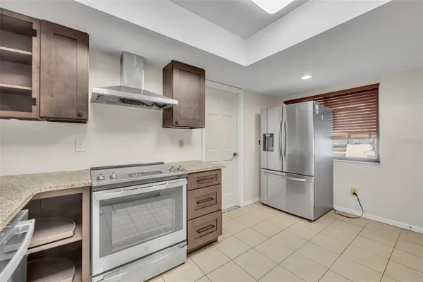 a kitchen with cabinets and stainless steel appliances