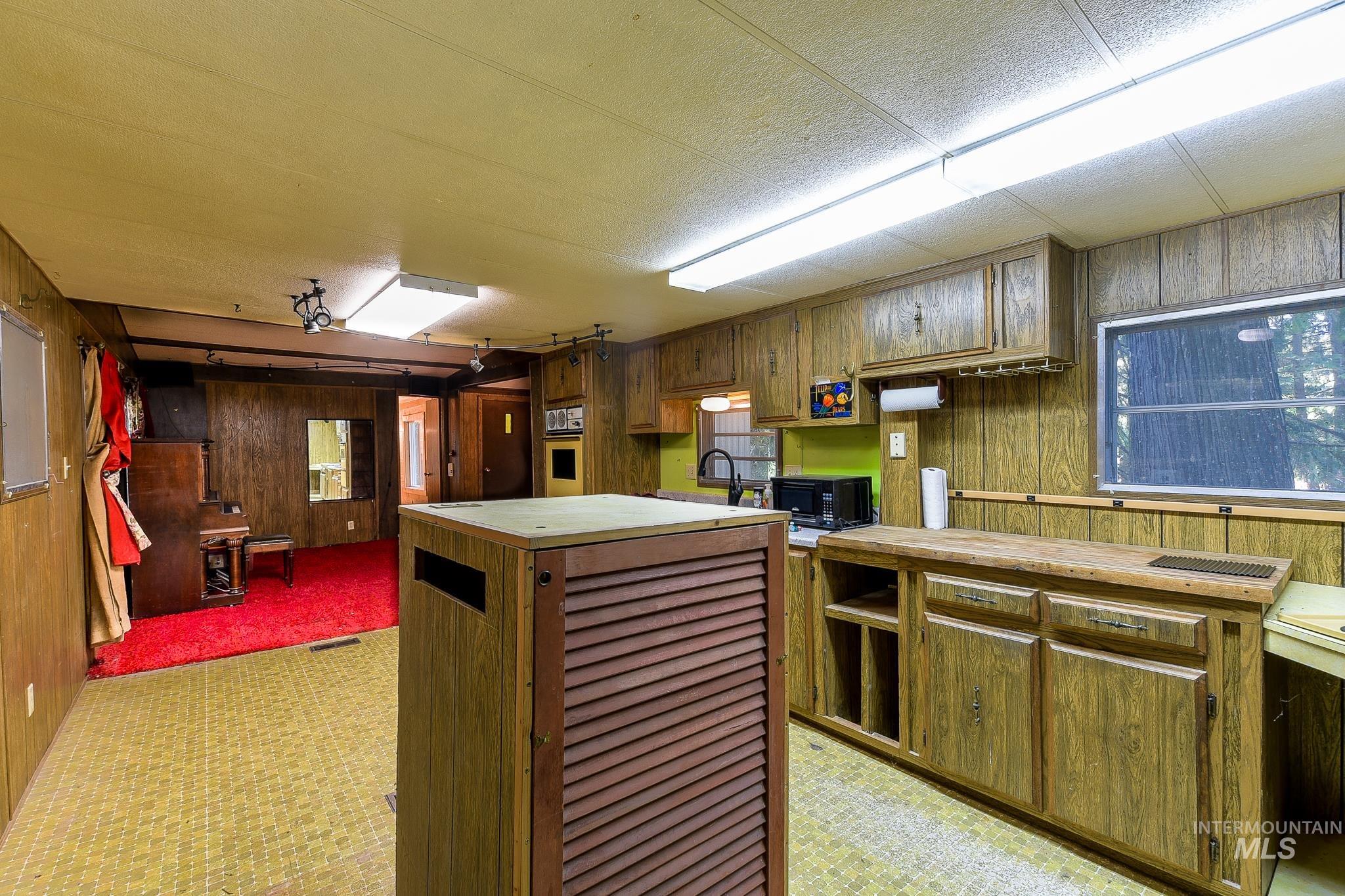 1206 Idlers Rest Road Moscow, ID 83843 - Photo 13 of 47 Kitchen area featuring wood-grain cabinetry, a built-in oven, and a window with exterior views