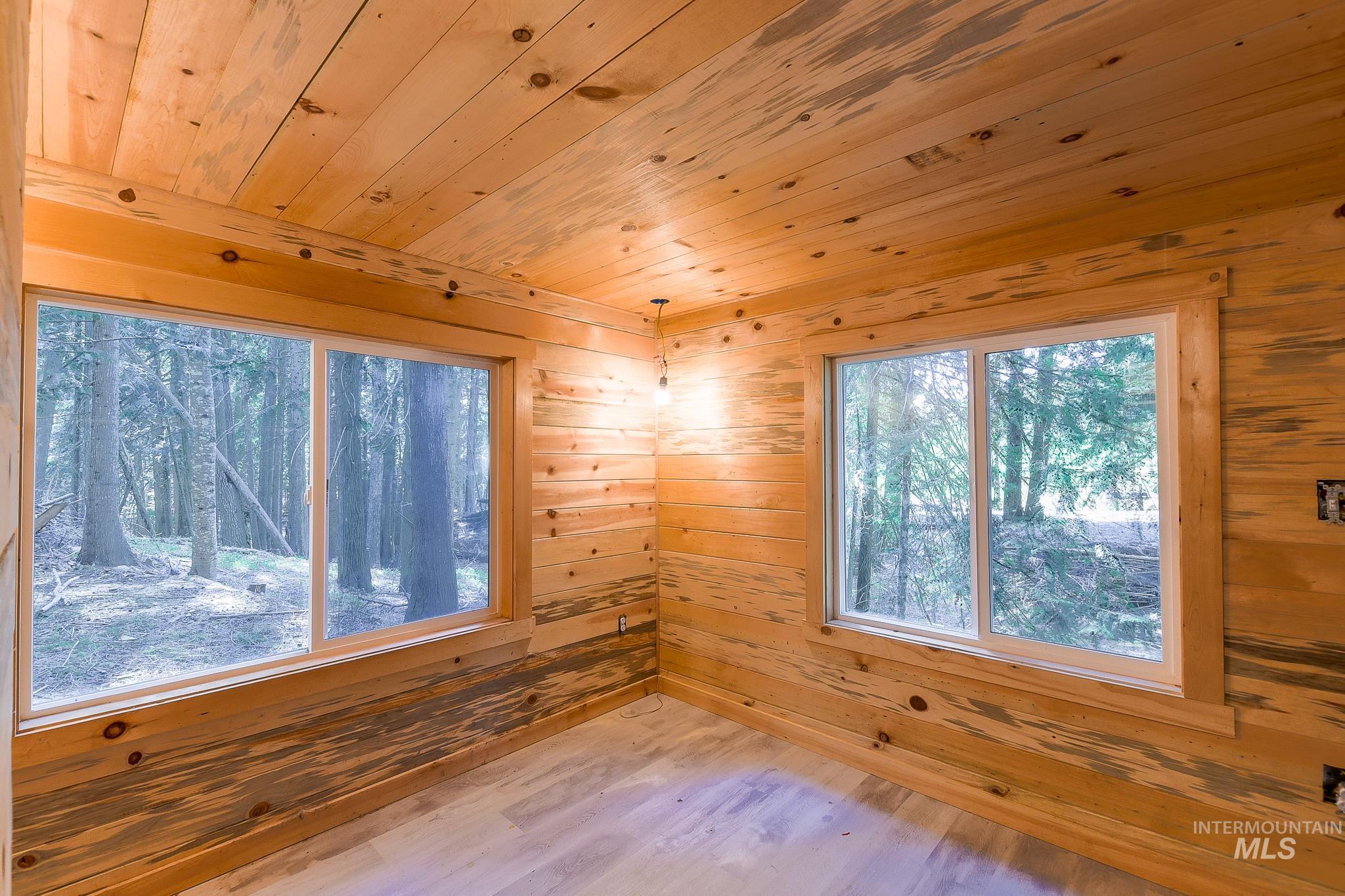 1206 Idlers Rest Road Moscow, ID 83843 - Photo 20 of 47 Interior room with wood-finish paneling on walls and ceiling