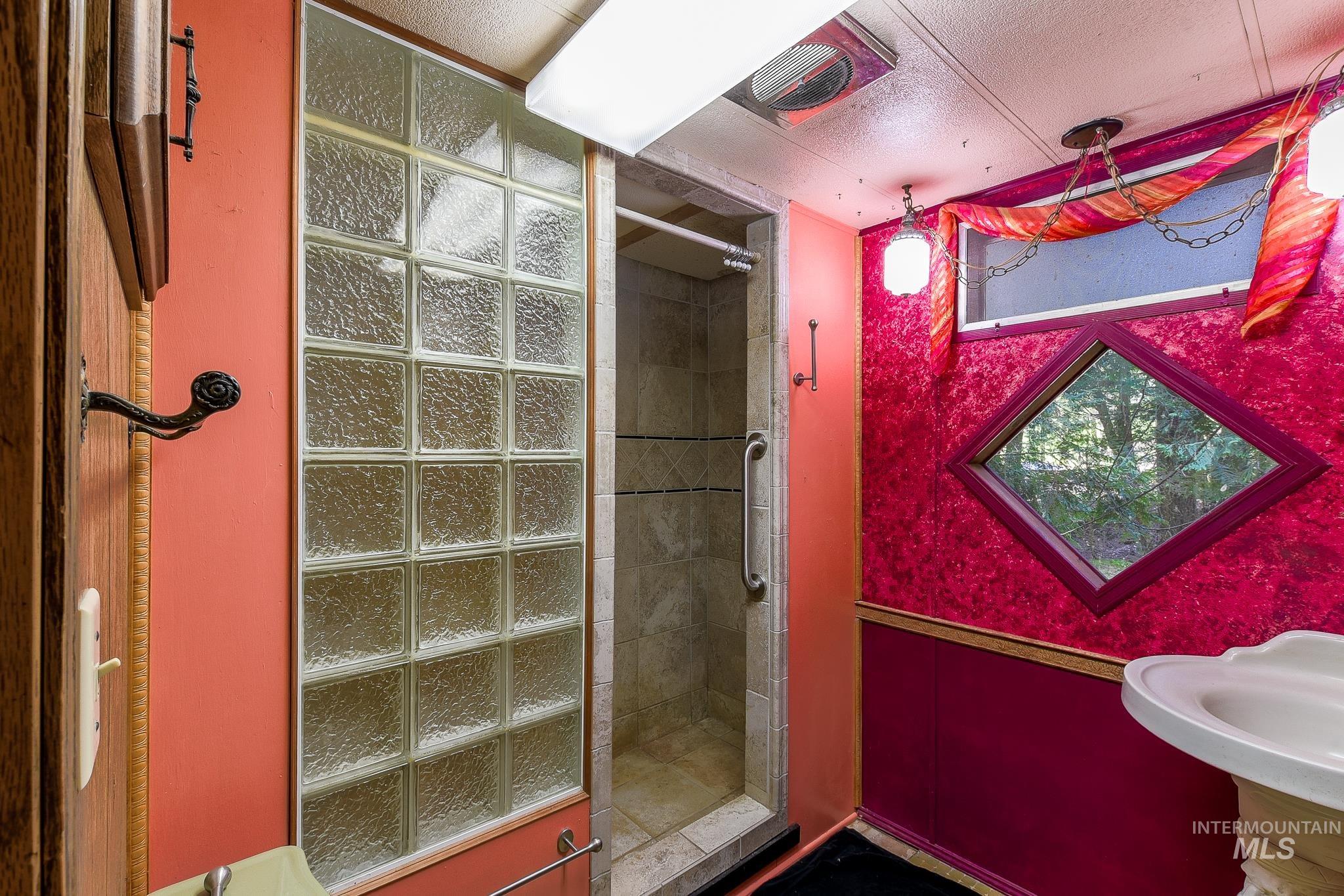 1206 Idlers Rest Road Moscow, ID 83843 - Photo 23 of 47 Glass block shower enclosure with a tile interior and grab bar