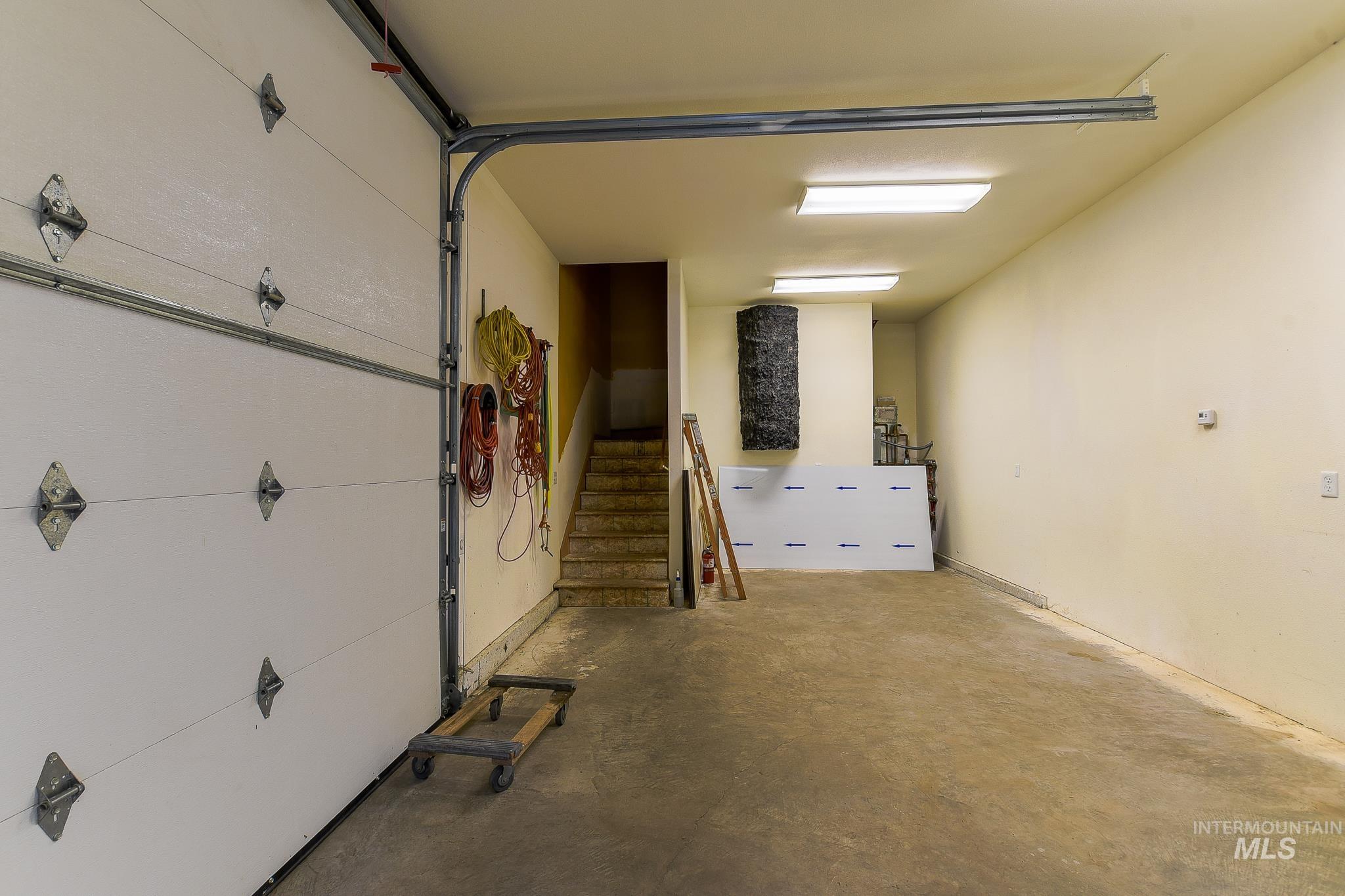 1206 Idlers Rest Road Moscow, ID 83843 - Photo 27 of 47 Spacious garage featuring a concrete floor, bright overhead lighting, and white walls