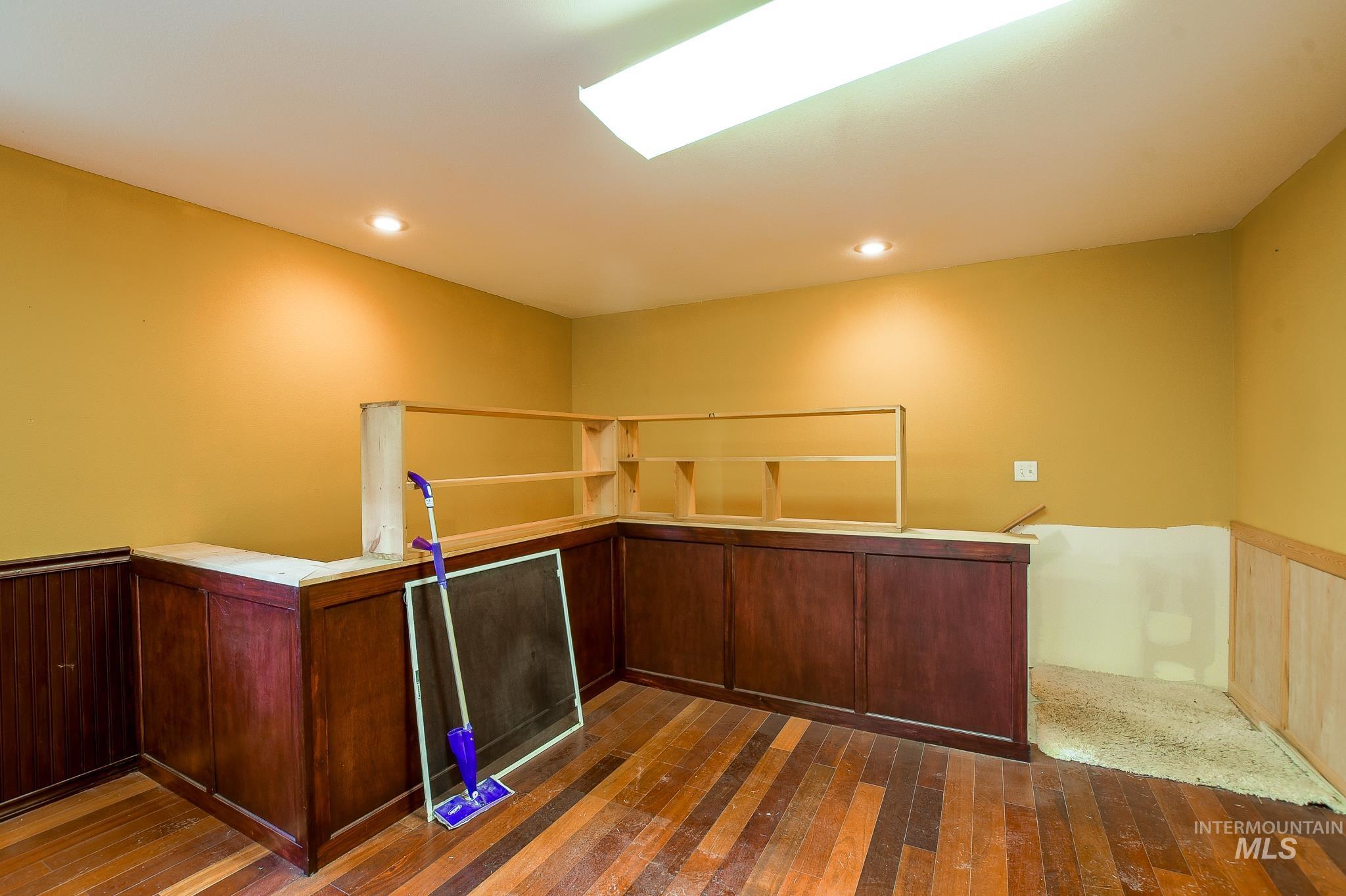 1206 Idlers Rest Road Moscow, ID 83843 - Photo 32 of 47 Room featuring dark wood-finish flooring, built-in shelving, recessed lighting, and a fluorescent ceiling fixture