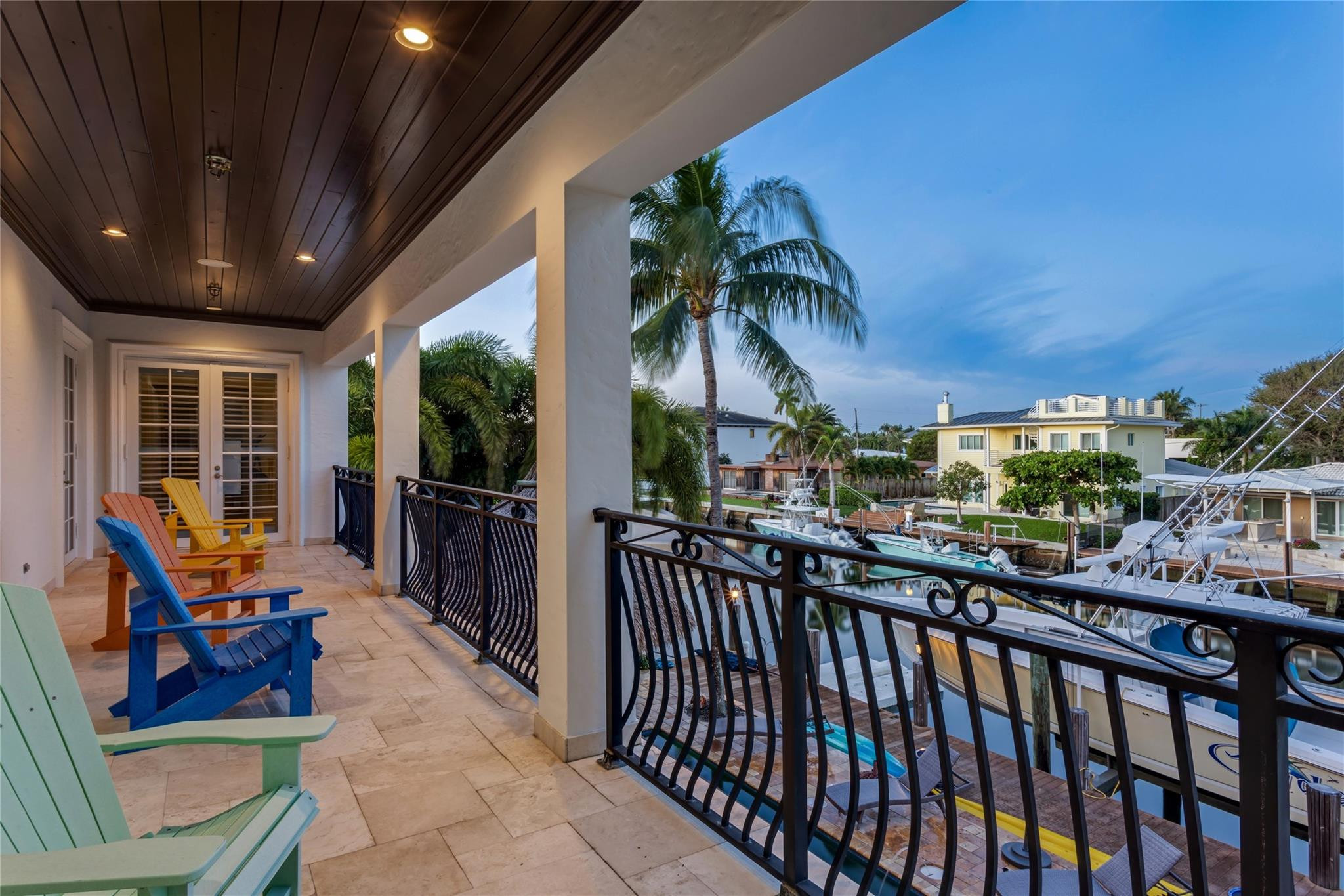 3489 Northeast 30th Avenue Lighthouse Point, FL 33064 - Photo 39 of 42 a view of a balcony with chairs and potted plants