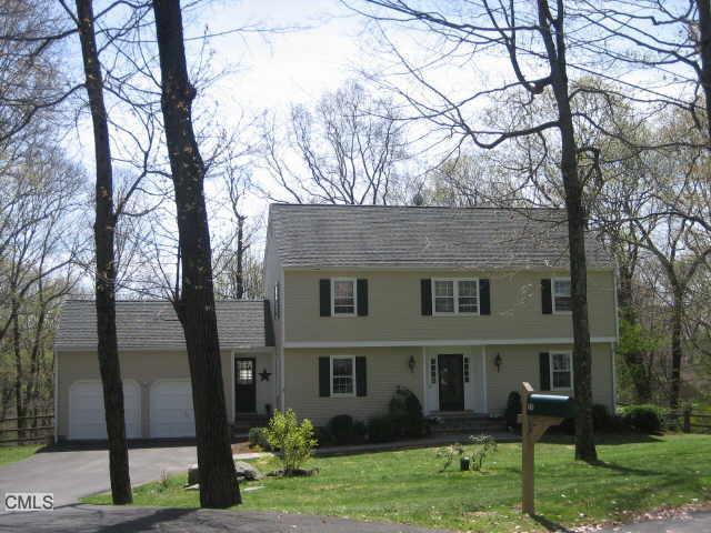 25 Revere Place Ridgefield, CT 06877 - Photo 1 of 1 a view of a yard in front of a house with plants and large tree