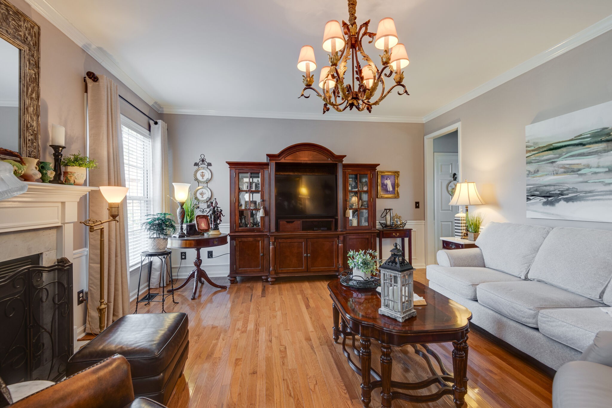 111 Meadowood Loop Burns, TN 37029 - Photo 22 of 73 a living room with furniture a fireplace and a chandelier