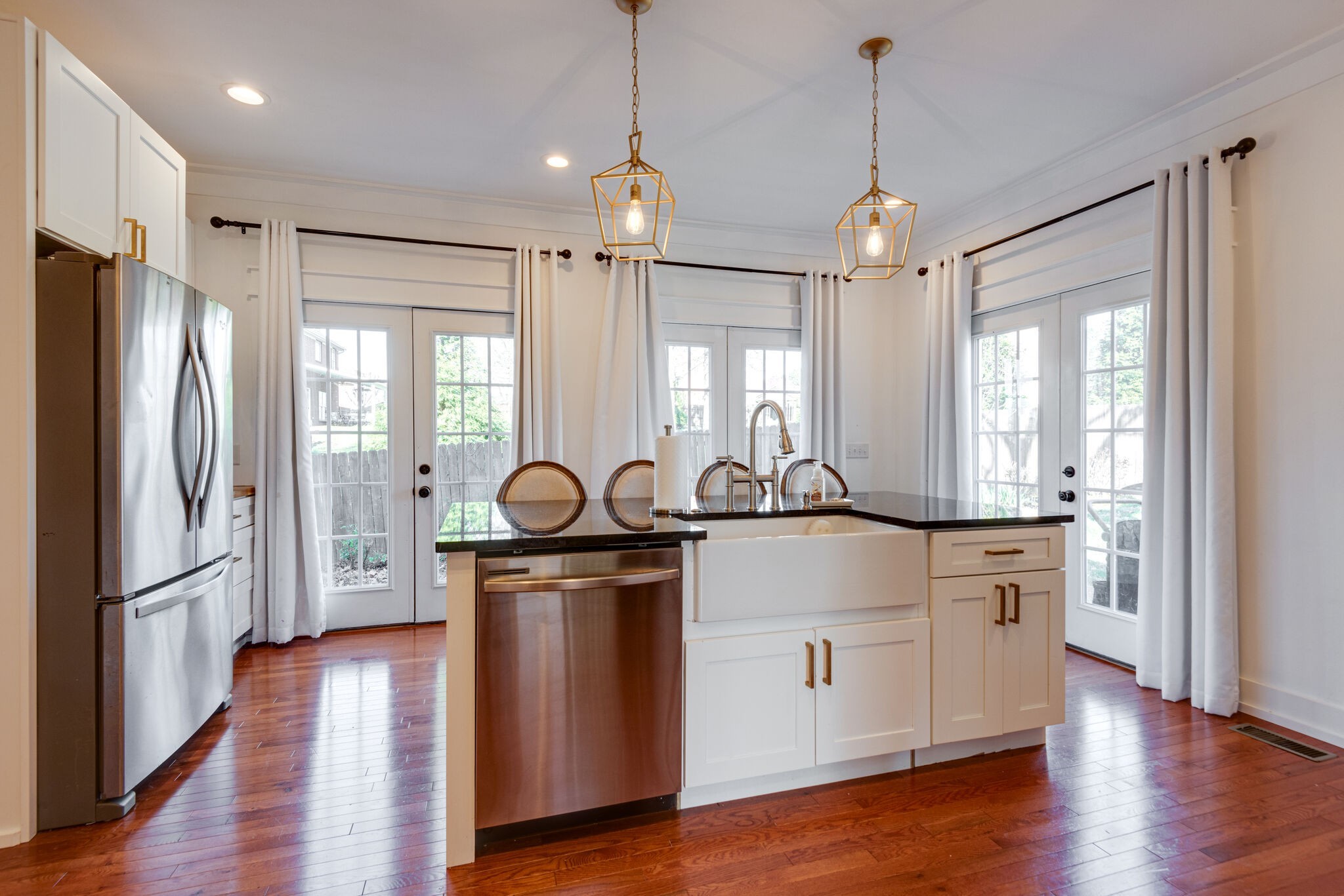 111 Meadowood Loop Burns, TN 37029 - Photo 46 of 73 a kitchen with stainless steel appliances granite countertop a refrigerator a sink dishwasher a stove and white cabinets with wooden floor