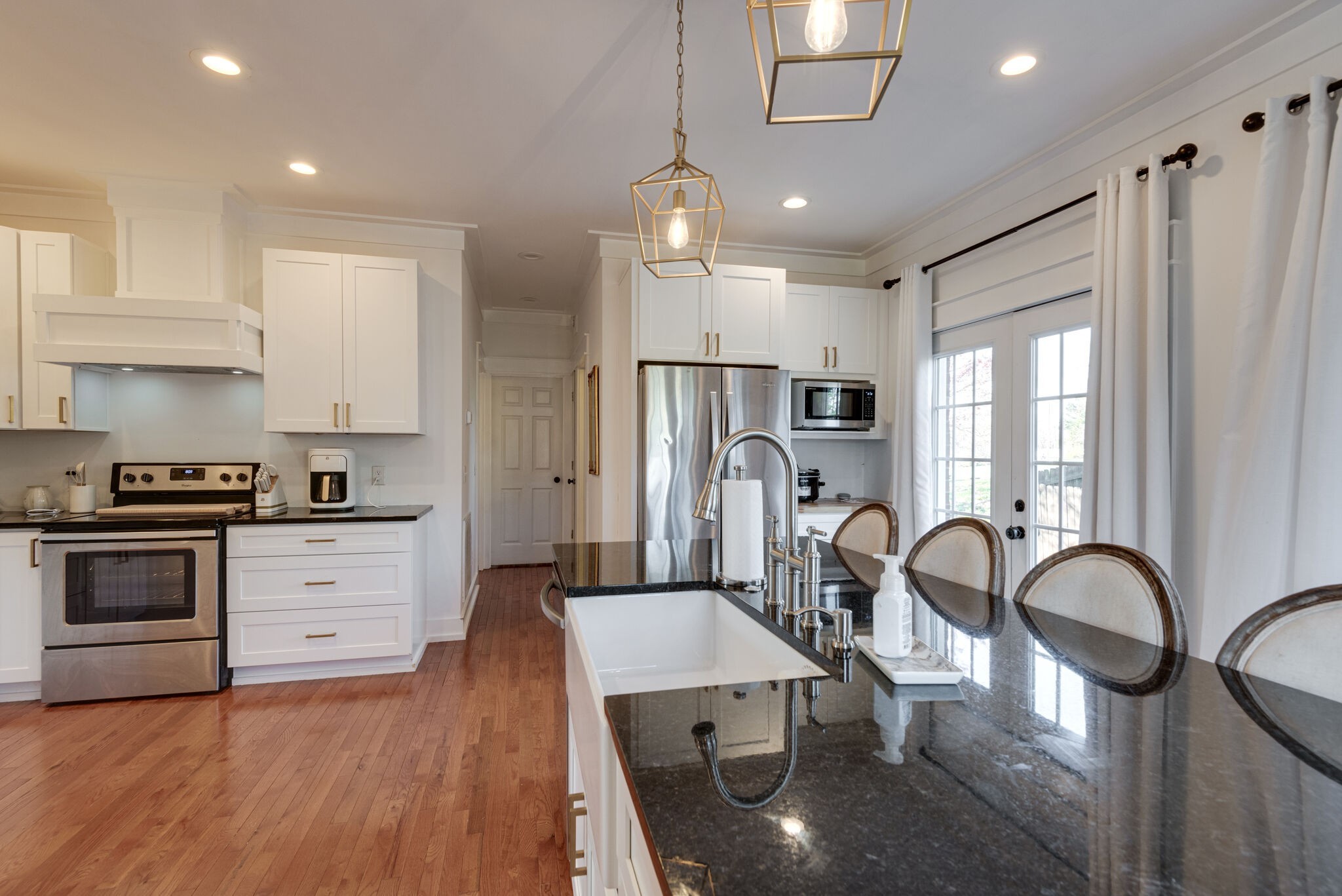111 Meadowood Loop Burns, TN 37029 - Photo 47 of 73 a kitchen with stainless steel appliances granite countertop a refrigerator a stove a sink dishwasher with a dining table and chairs with wooden floor