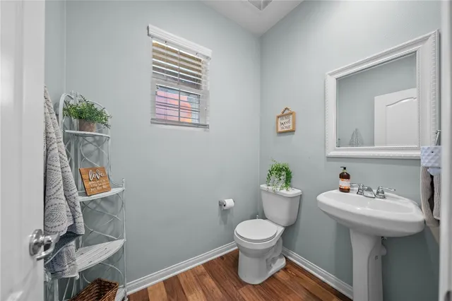 a bathroom with a sink toilet and a mirror