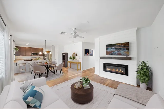 a living room with furniture potted plant and a fireplace