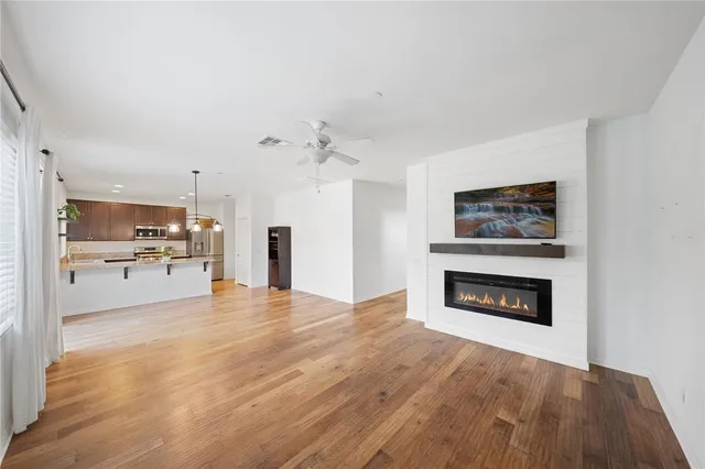 a view of kitchen with granite countertop cabinets and fireplace