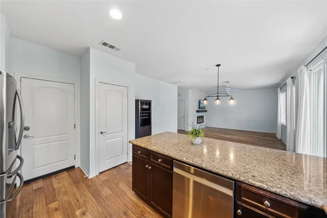 a kitchen with stainless steel appliances granite countertop a sink and a refrigerator