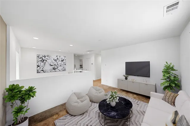 a living room with furniture and a potted plant