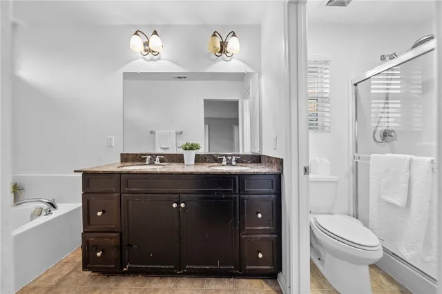a bathroom with a sink vanity mirror and toilet