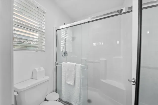 a bathroom with a shower and a toilet