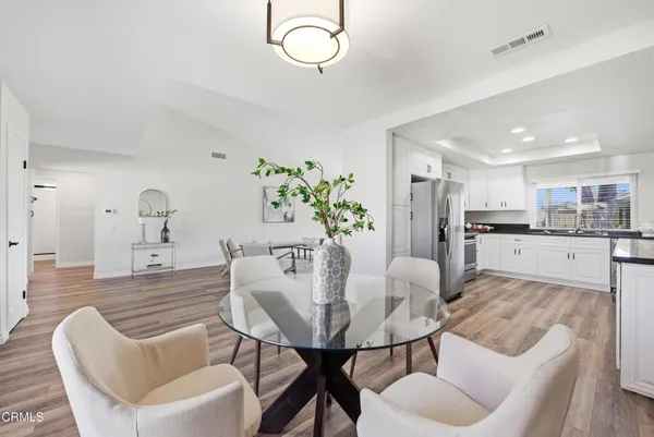 a dining room with furniture and wooden floor