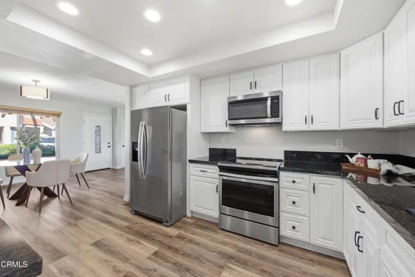 a kitchen with stainless steel appliances a stove microwave and refrigerator