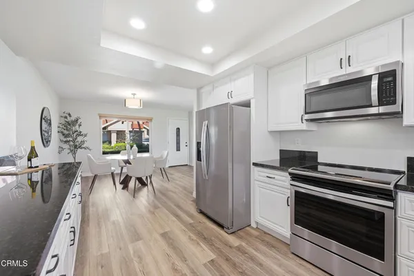 a kitchen with granite countertop a sink and a stove top oven