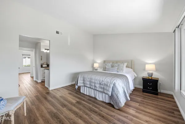 a bathroom with a granite countertop sink mirror and a toilet